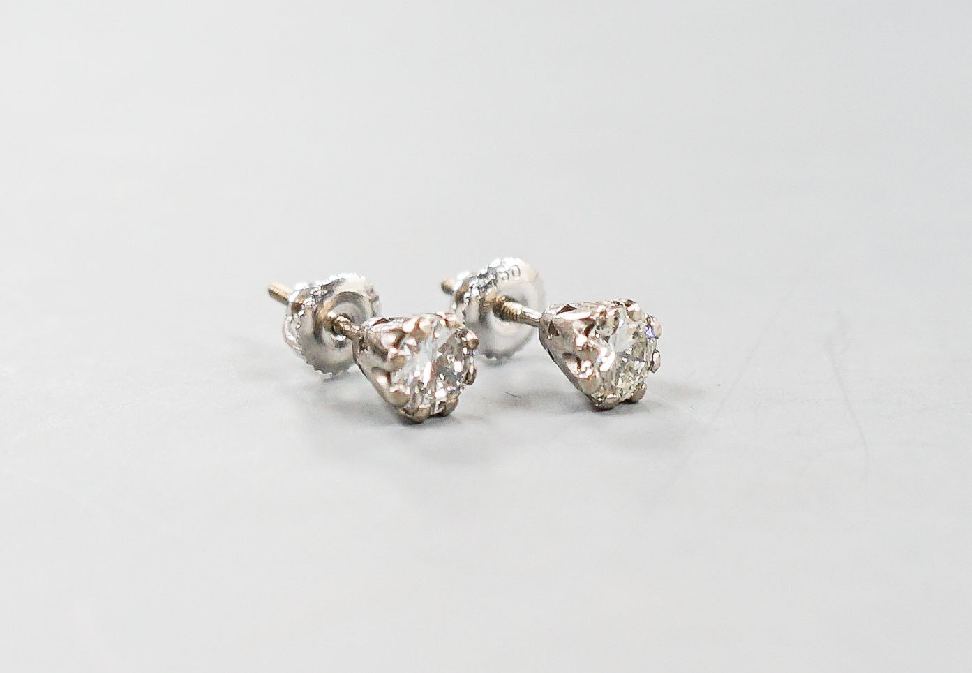 A pair of 750 white metal and solitaire diamond ear studs, gross weight 2 grams